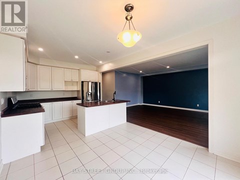 A kitchen with white cabinets and a dark countertop.