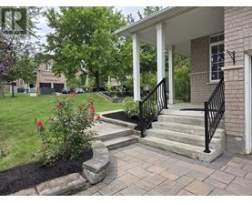 A house with a white porch and a black railing.