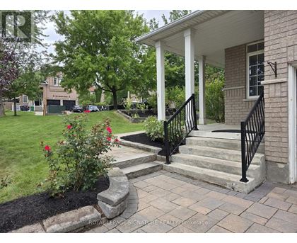 A house with a white porch and a black railing.