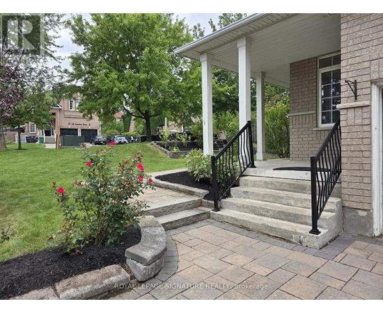 A house with a white porch and a black railing.