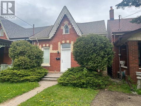 A brick house with a white door and a small porch.