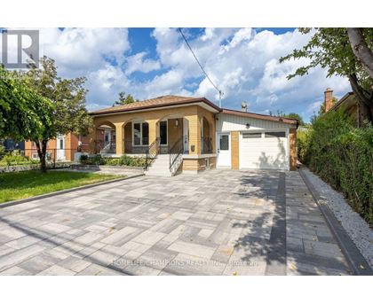 A house with a driveway in front of it is for sale.