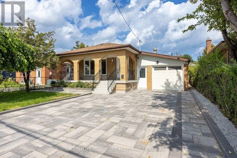 A house with a driveway in front of it is for sale.