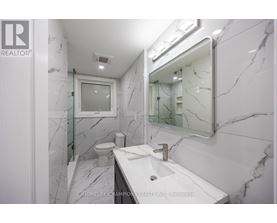 A bathroom with marble floors and walls.