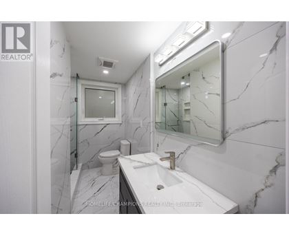 A bathroom with marble floors and walls.