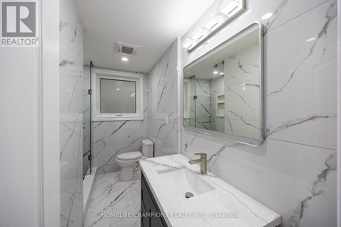 A bathroom with marble floors and walls.