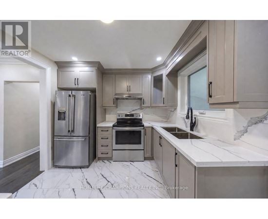 A modern kitchen with a marble floor and stainless steel appliances.