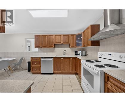 A kitchen with wooden cabinets and white appliances.