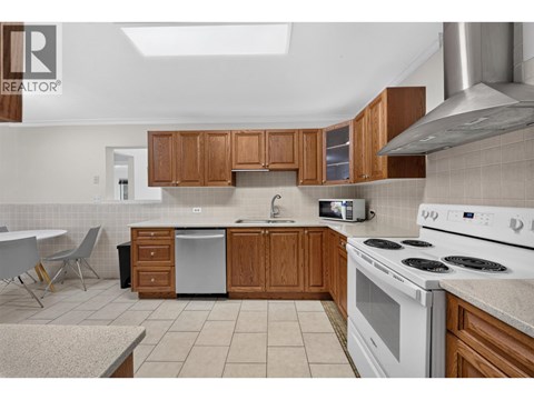 A kitchen with wooden cabinets and white appliances.