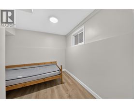 A bedroom with a bed and a window.