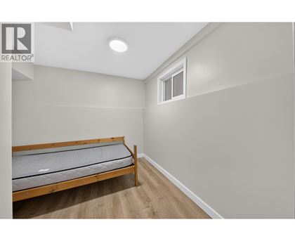 A bedroom with a bed and a window.