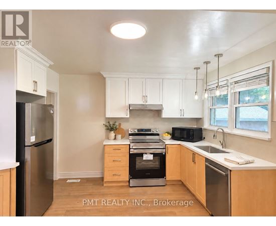A kitchen with a black fridge and stove top oven.