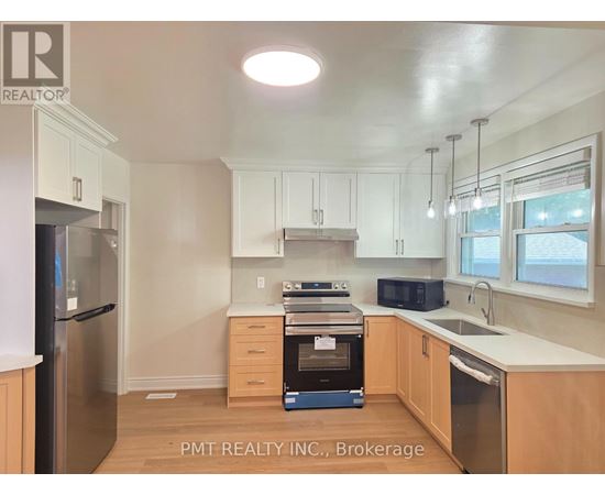 A kitchen with white cabinets and stainless steel appliances.