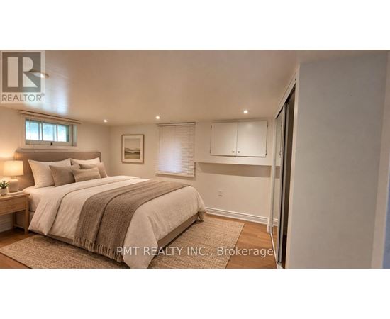 A bedroom with a large bed and a window.