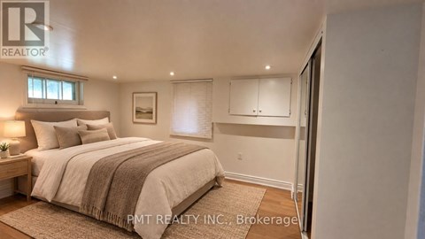 A bedroom with a large bed and a window.