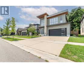 A modern house with a large garage is for sale.
