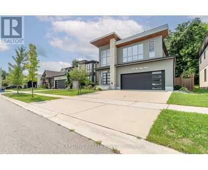 A modern house with a large garage is for sale.