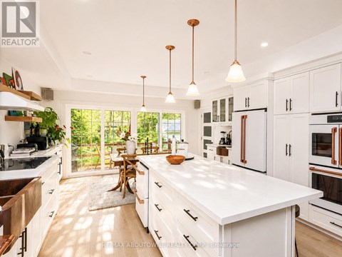 A modern kitchen with white cabinets and a large island.