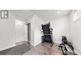 A room with a treadmill and exercise equipment.