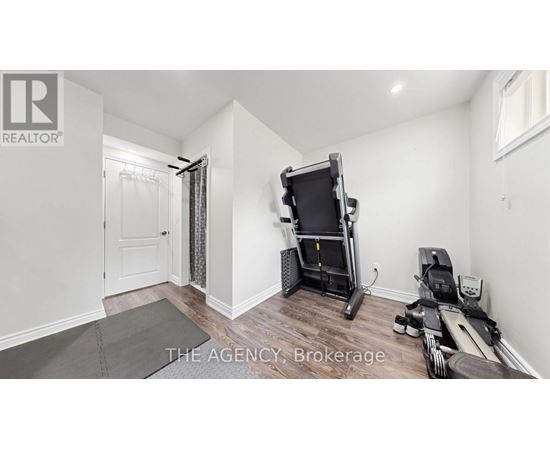 A room with a treadmill and exercise equipment.