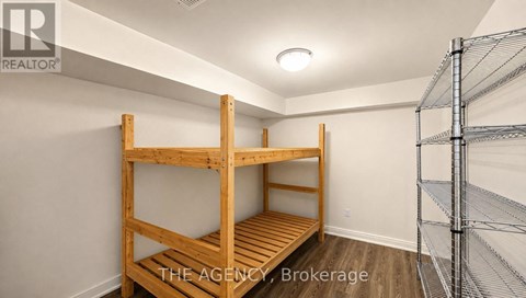 A room with a bunk bed and a shelving unit.