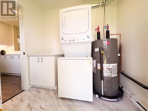 A white dishwasher and a white washing machine in a kitchen.