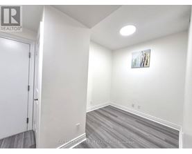 A room with a door and a picture on the wall.