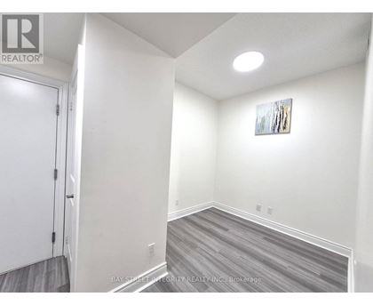 A room with a door and a picture on the wall.
