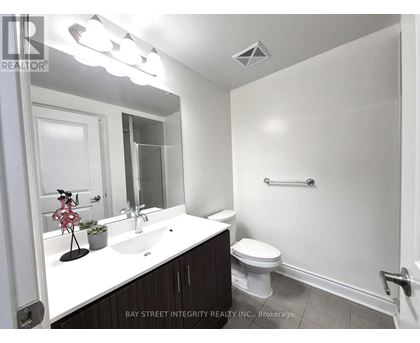 A white sink and toilet in a small bathroom.