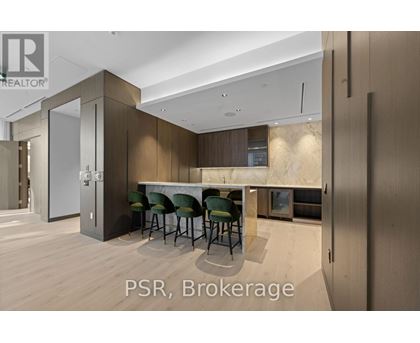 A modern kitchen with a dining table and chairs.