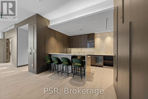 A modern kitchen with a dining table and chairs.