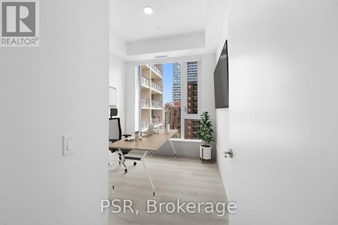 A modern living room with a view of a cityscape through the window.