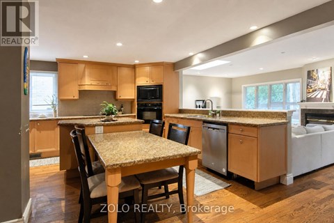 A kitchen with wooden cabinets and a granite countertop.