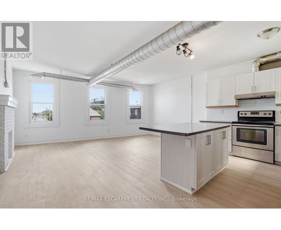 A kitchen with white cabinets and a black countertop.
