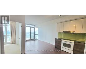 A kitchen with white appliances and green backsplash.