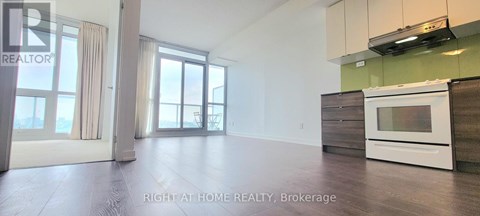 A spacious kitchen with a white oven and wooden cabinets.