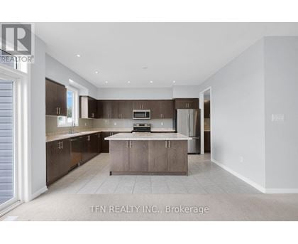 A modern kitchen with brown cabinets and a white countertop.