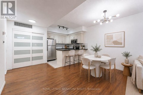 A well-lit kitchen with a dining table set for four.