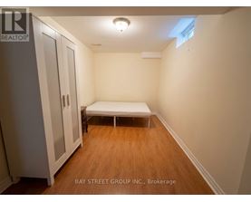 A bedroom with a bed and a wardrobe.