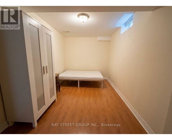 A bedroom with a bed and a wardrobe.