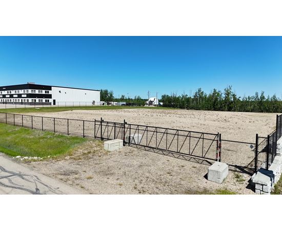 A white building with a black fence in front of it.