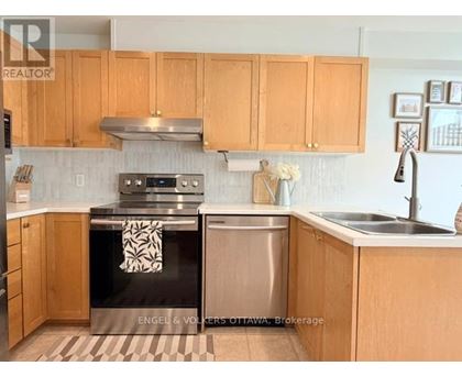 A kitchen with wooden cabinets and a black stove top oven.