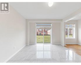 A large empty room with a view of a building across the street.