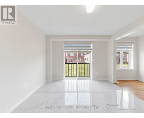 A large empty room with a view of a building across the street.