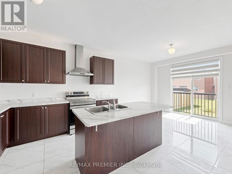 A kitchen with brown cabinets and a white counter top.