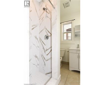 A bathroom with a marble patterned wall.