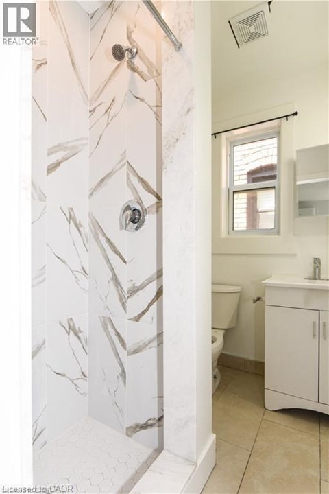 A bathroom with a marble patterned wall.