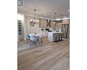 A modern kitchen with a dining table and chairs.