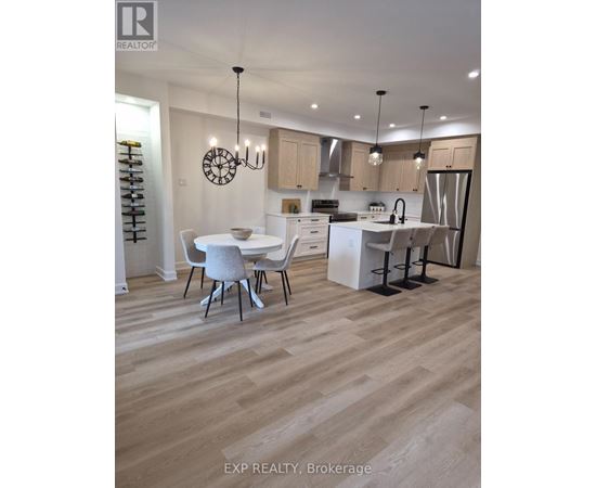 A modern kitchen with a dining table and chairs.
