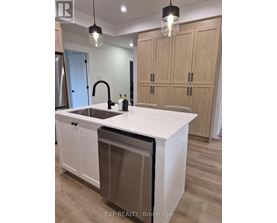 A kitchen with a white countertop and wooden cabinets.
